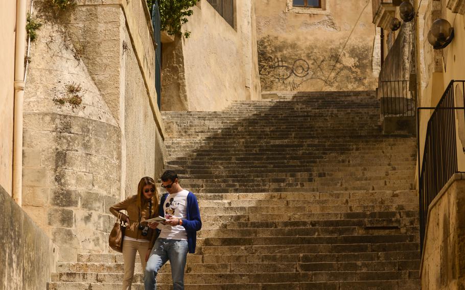 A young couple explores the nooks and crannies of Noto, Sicily.