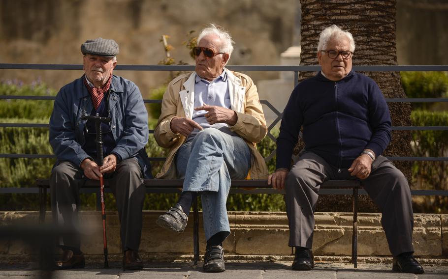 Local residents with no particular place to go have a morning chat in Noto, Sicily.