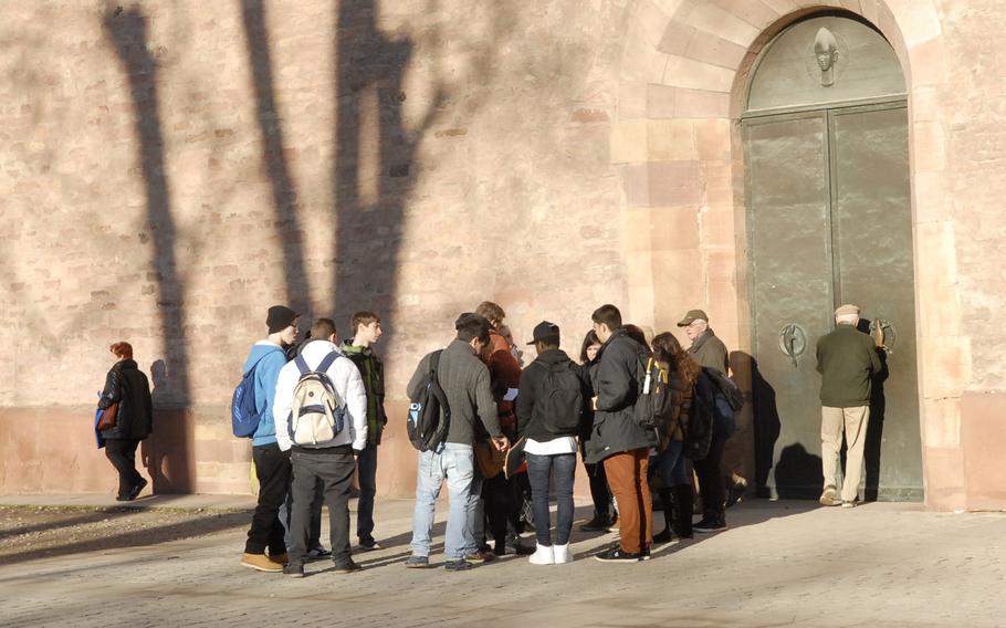 Visitors to the Speyer cathedral  gather outside a nondescript entrance to the old basilica: an unmarked side door. Entrance to the cathedral is free.