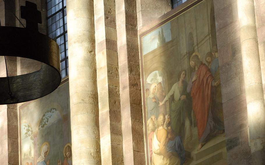 Paintings depicting scenes from the Bible are bathed in natural light inside the cathedral in Speyer, Germany.