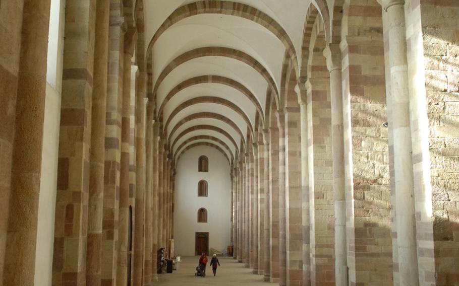 Visitors look tiny inside the massive cathedral in Speyer, Germany. The massive rock basilica is the largest surviving Romanesque cathedral. Original construction finished in 1061, though much of the structure was destroyed and rebuilt over the years.