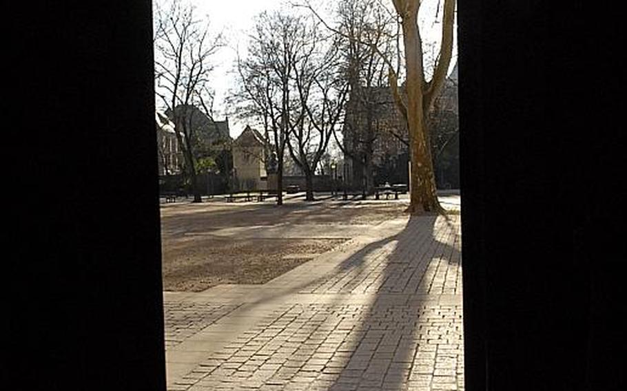 A side door leads to a stone courtyard on the south side of the cathedral in Speyer, Germany.