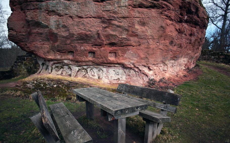A picnic table sits at the base of the pillar of sandstone that was once a major structural support for Burg Beilstein, a castle ruin near Kaiserslautern, Germany.