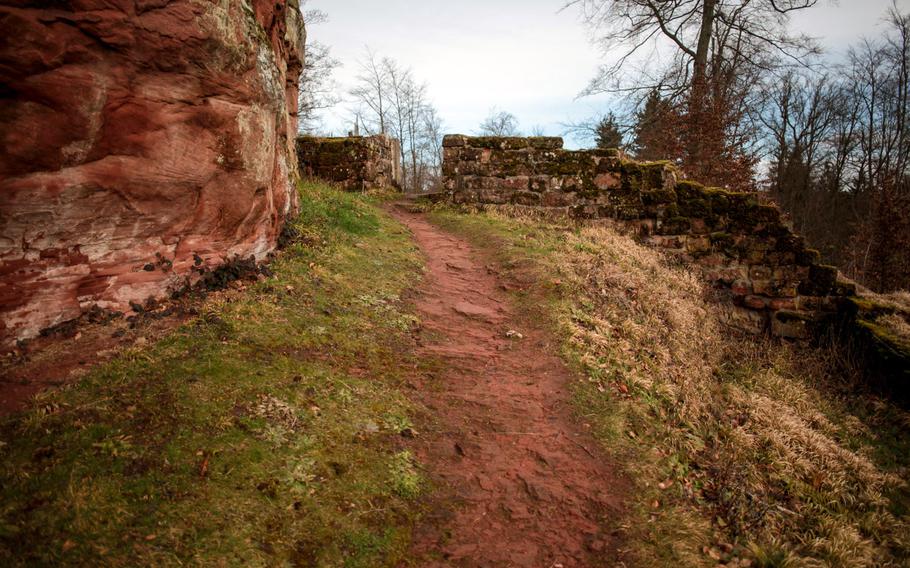 A path around Burg Beilstein's central pillar goes through a part of a wall that was probably partially restored in the 1800s. The ruin is in the woods outside the city of Kaiserslautern, Germany.
