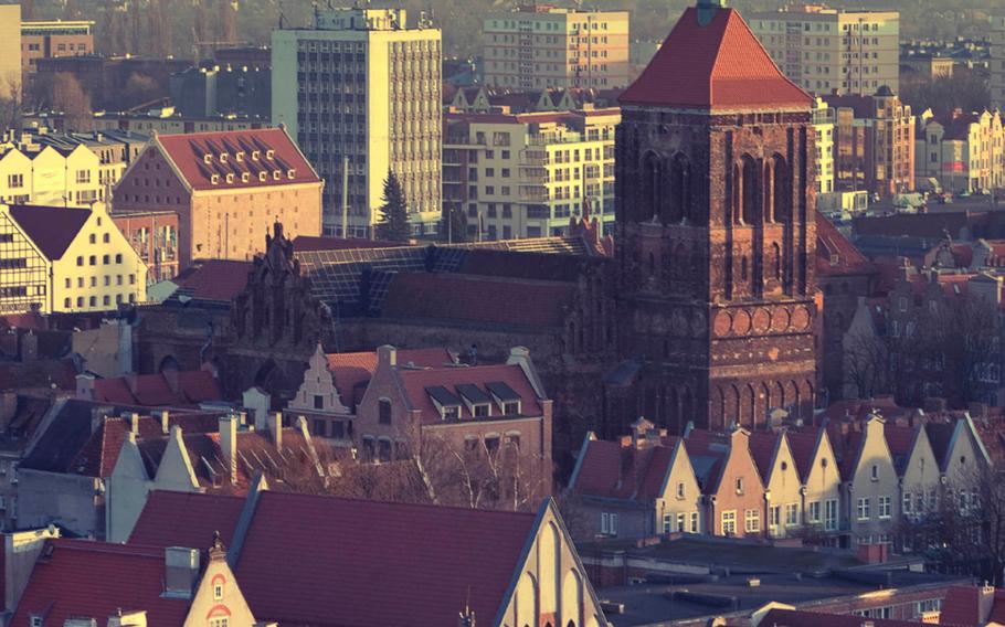 The Old Town skyline in Gdansk, Poland, provides a stark contrast to the city's modern high-rise buildings in the background.
