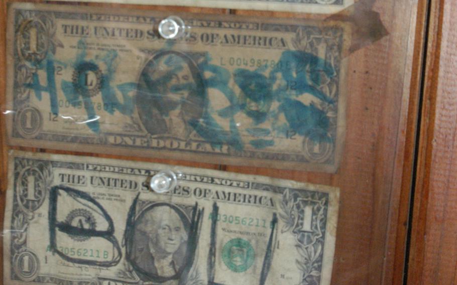 Posted behind a counter of a replica bar that catered to servicemembers in the '50s through the '70s, are dollar bills with messages and words they left behind, many of them before being deployed to Vietnam. The Okinawa Gallery of Culture and History in Okinawa City displays many examples.