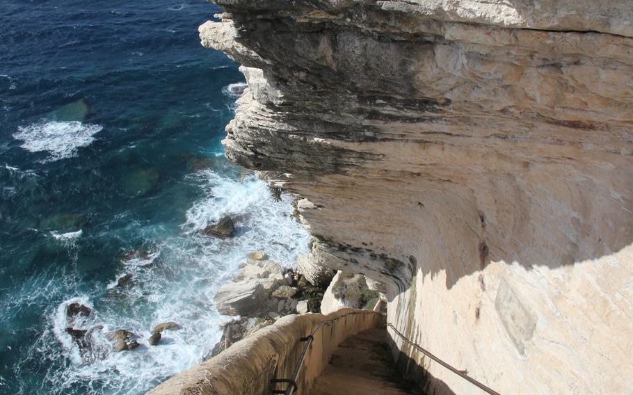 Steep stairs at the Escalier du Roi d'Aragon in Bonifacio offer adventurers a breathtaking descent to the sea.