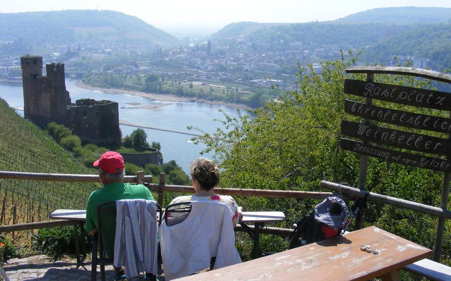 A couple enjoys a scenic outlook that’s also the site of an unmanned wine bar. Hammond’s vineyards lie just above this popular rest point. In the background is Burg Ehrenfels, a ruin since 1689.