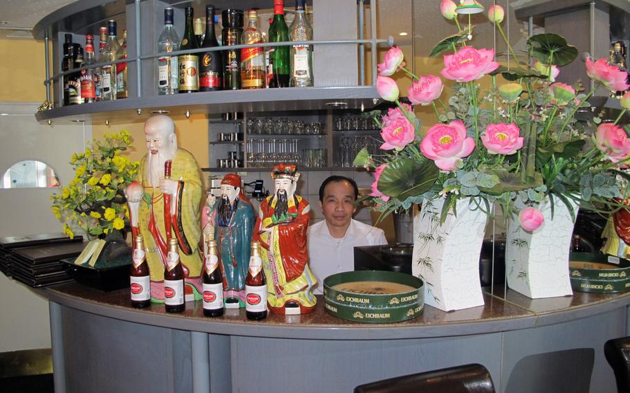 Tran Cong Nhan, owner of the Restaurant Saigon in Kaiserslautern sits behind a colorfully decorated bar. If you want to dine here, it's best to make reservations --- the restaurant has only about 10 tables.