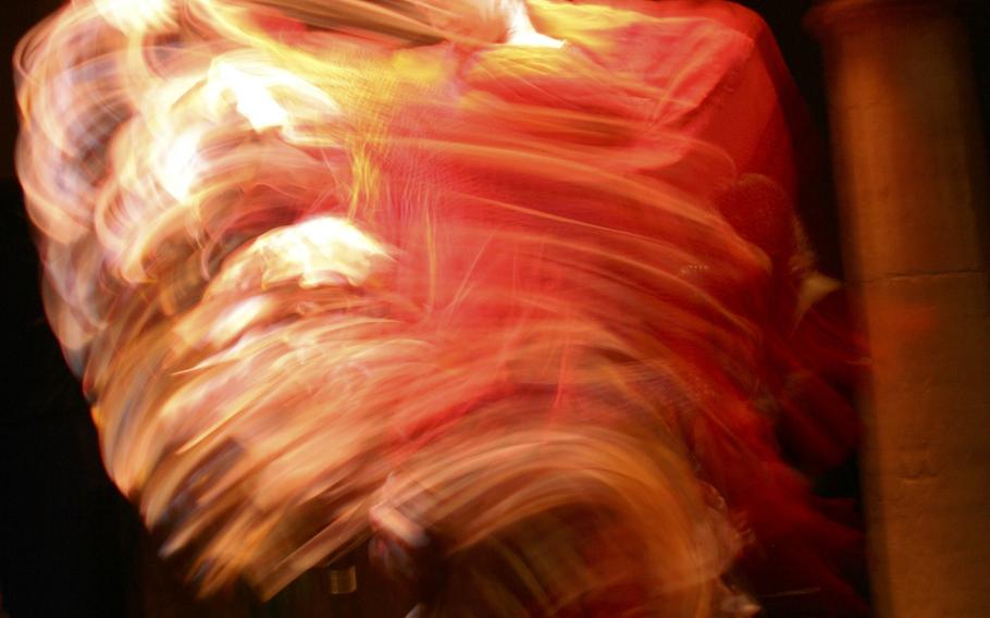 A spirited dancer swishes her costume in a frenzy of flamenco dancing in Seville, Spain.