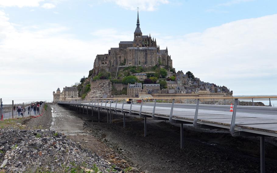 A new causeway bridge is under construction, and almost completed, that links the French mainland with Mont-St-Michel, about 1,100 yards out to sea. The new bridge -- and the destruction of the old causeway road -- will allow the waters of the Bay of Mont-St-Michel to flow freely around the island.
