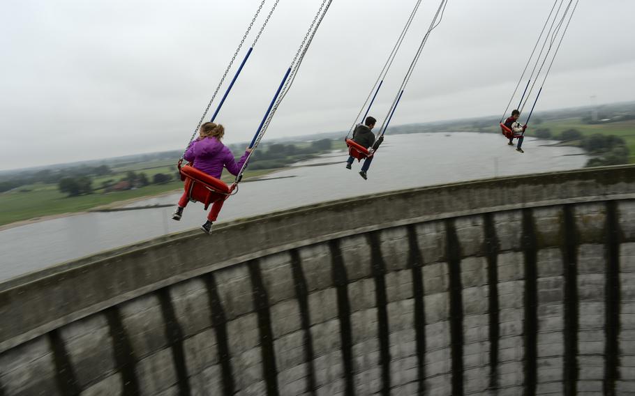 Riders of Kernie's Family Park's main attraction, the 190-foot-high vertical swing, get a view of the Rhine River and the park's surrounding area once the swing lifts over the top of the cooling tower.