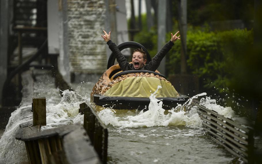 A brave rider of the Wild Water Train at Kernie's Family Park reacts after splashing into a pool of water  at Kalkar, Germany.