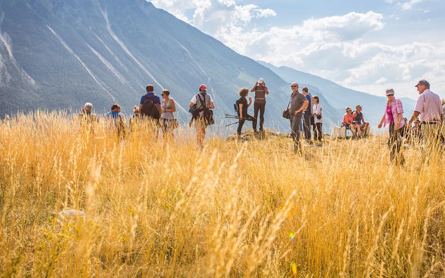 A hiking group enjoys the high-altitude scenery above Leukerbad, Switzerland.