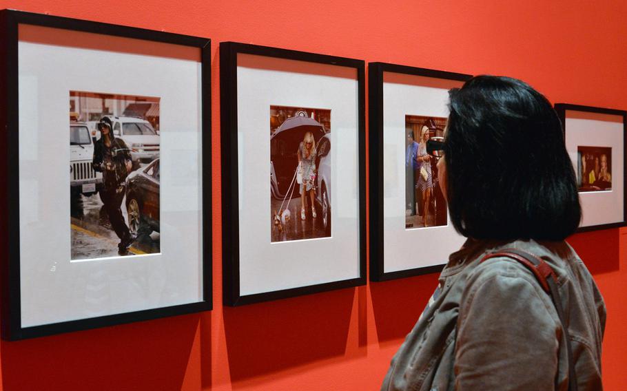 A visitor to the Schirn's paparazzi exhibit looks at photos of Paris Hilton.  