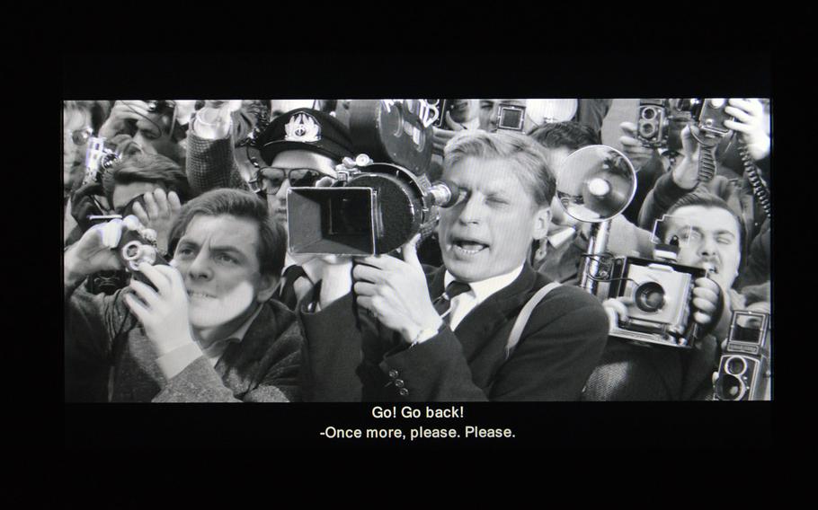 The press try to photograph Anita Ekberg getting off a plane in Federico Fellini's "La Dolce Vita." A photographer in the film was named Paparazzo, giving a whole branch of photographers a name.