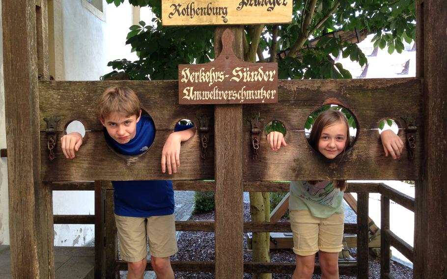 My two youngest kids, Nicholas and Avery, take a few moments to experience life in a stock outside the  Criminal Museum in Rothenburg.