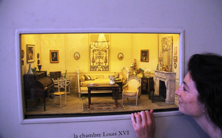 A visitor takes a peek into the Louis XVI room at the Musuem of Miniatures in Albi, France. The museum houses 55 miniature rooms, all made by a woman, now 79 years old, who started the project 40 years ago.