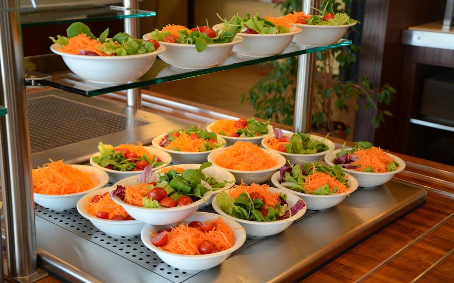 Bowls of freshly made salads fill shelves at the self-serve area at Ristorante Pizzeria Doria in Orsago, Italy.