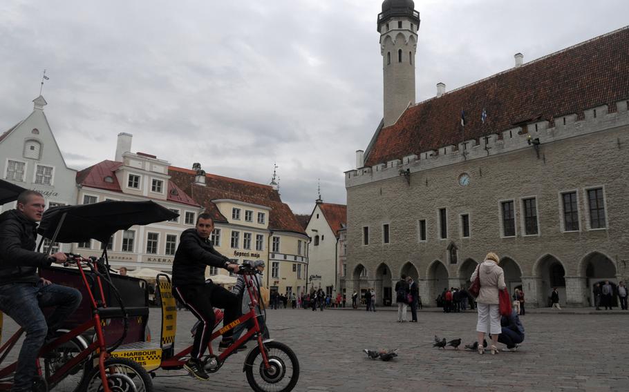 The tourism industry is alive in Tallinn's main square, near the town hall, where pedicabs roam for fares and restaurant hawkers dressed in medieval garb hand out menus.