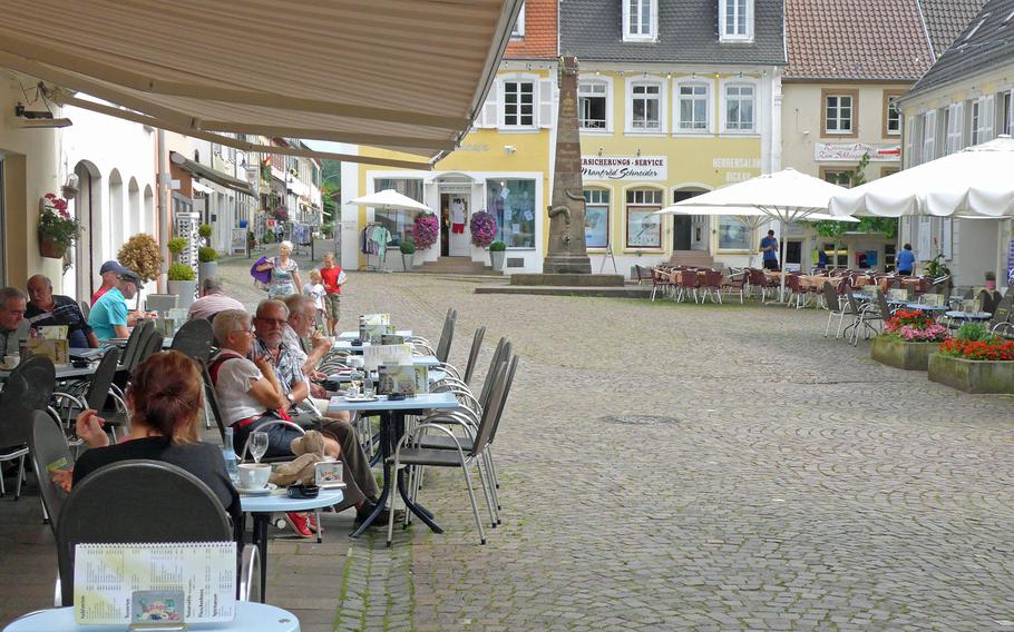 The cafe-and-restaurant-lined market square in Blieskastel, Germany, looking toward the Napoleon Fountain.