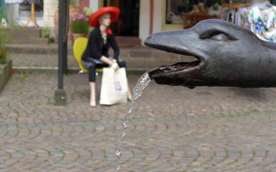 Water spouts from a snake's mouth of the Napoleon Fountain in Blieskastel, Germany. Because the snake wraps around and protrudes from the fountain, it is also known as the Schlangenbrunnen, or Snake Fountain.