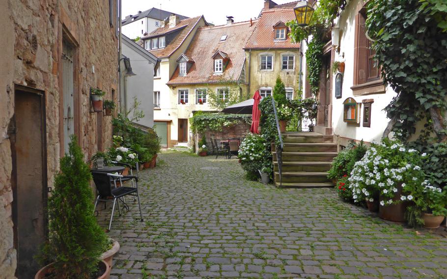 An old cobblestone street  in Blieskastel, Germany. The town is noted for its baroque architecture, but also has many other styles. At right is "Im Hinnereck," a popular restaurant.