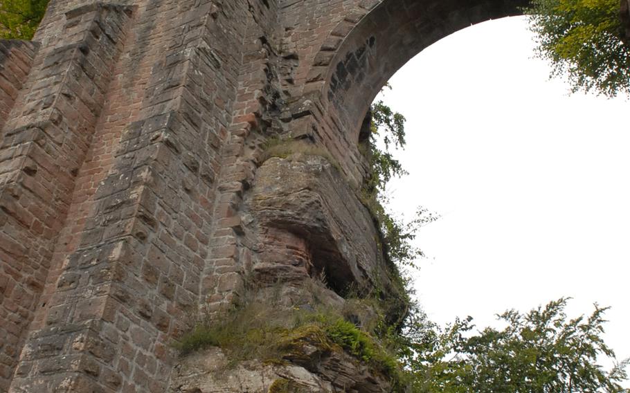 Trees and grass grow between the worn rocks of a section of the medieval-era Burg Trifels near Annweiler, Germany.