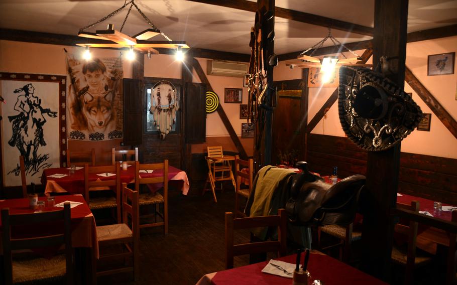 American Indian and western decor line the walls at Osteria dei Poeti, a tavern located at agriturismo al Ranch in Budoia, Italy.