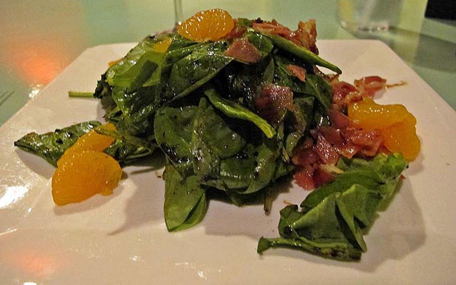 The spinach salad, topped with bacon and mandarin oranges, is available as an appetizer or a meal.