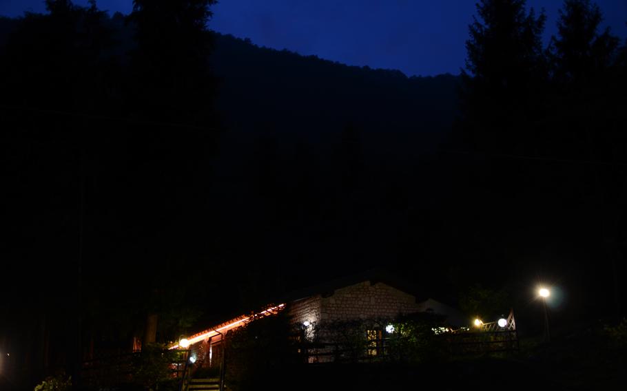 Few lights surround Il Rifugio, a restaurant in the foothills below Piancavallo, Italy, creating a tranquil setting for a peaceful meal.