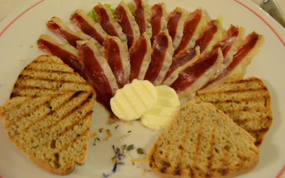 Smoked breast of goose, a thinly sliced appetizer served at Il Rifugio, is similar to prosciutto and is shown here accompanied by walnut bread and lightly salted butter.