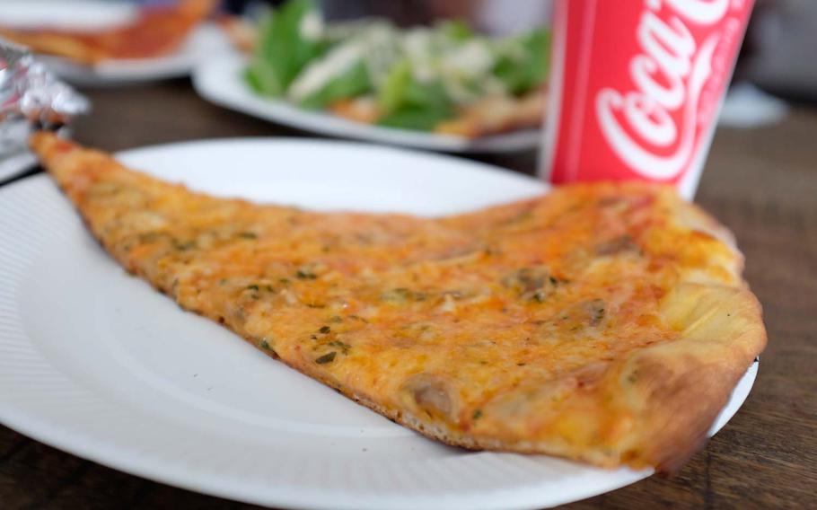 A slice of mushroom pizza at Pizza Slice runs about 500 yen, but for 1,000 yen you can get two slices and a drink during lunch hours.
