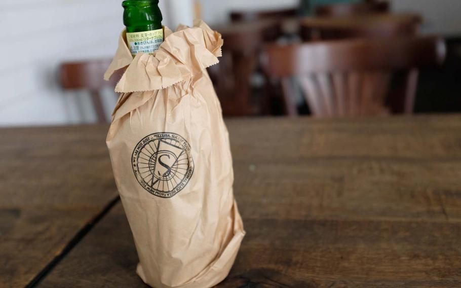 Beers at Pizza Slice are served with optional brown paper bag.