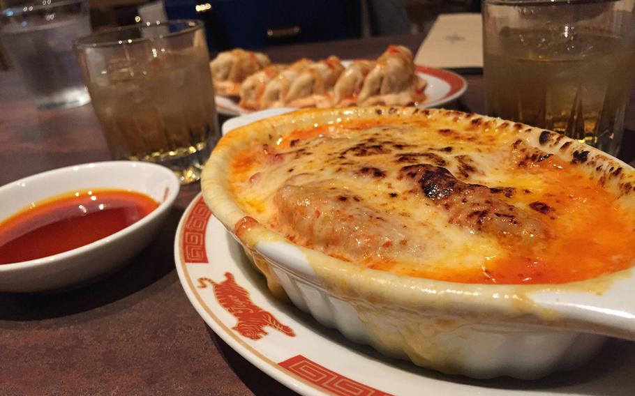 Gyoza smothered in cheese appears more like lasagna than dumplings at Tiger Gyoza Hall in Tokyo.