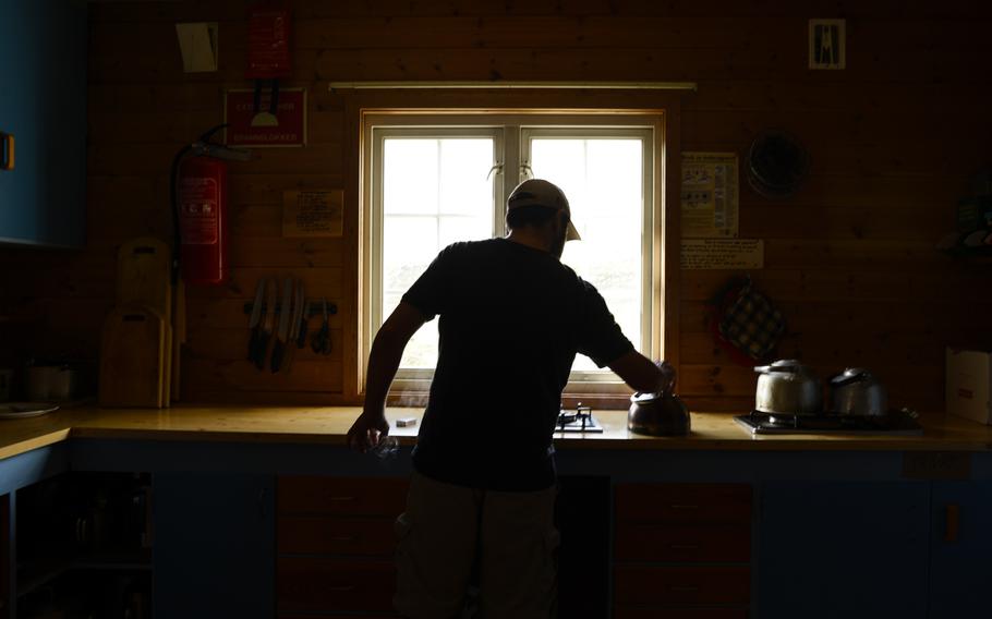 Making coffee at the Reinheim hut in Dovrefjell National Park, Norway.