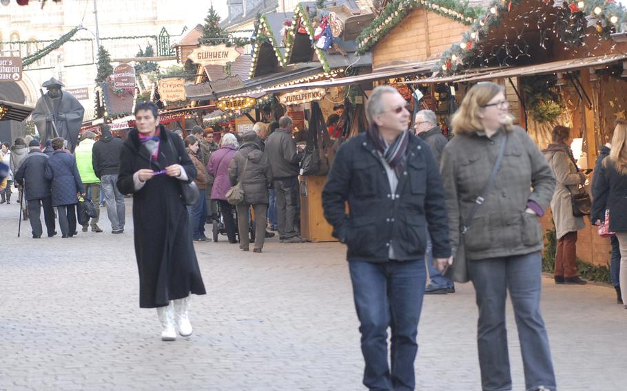 Visitors stroll along the cobblestone streets of Speyer during the city's annual Christmas market, in December 2013.