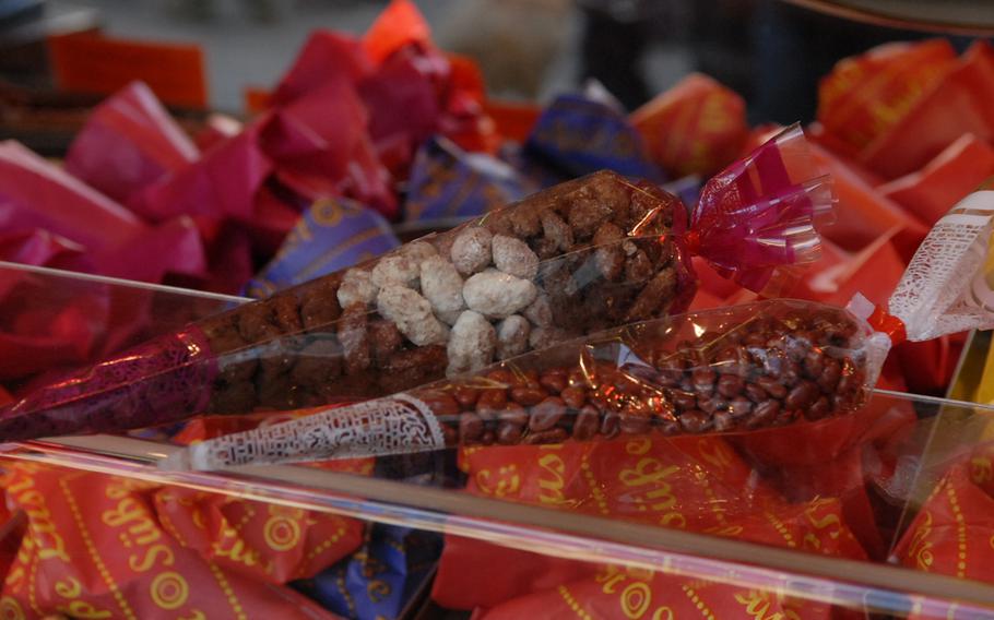 Candied, toasted almonds are a common treat at German Christmas markets; the Christmas market in Speyer, Germany, where these bundles of almond goodness were for sale in December 2013, is no exception.