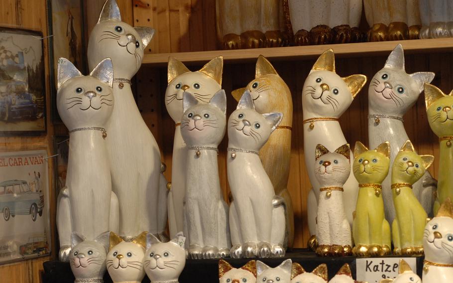 Wooden cats cock their heads from their perch inside a stall at the Speyer Christmas Market. The annual market in one of Germany's oldest cities is one of the few to remain open until early January.