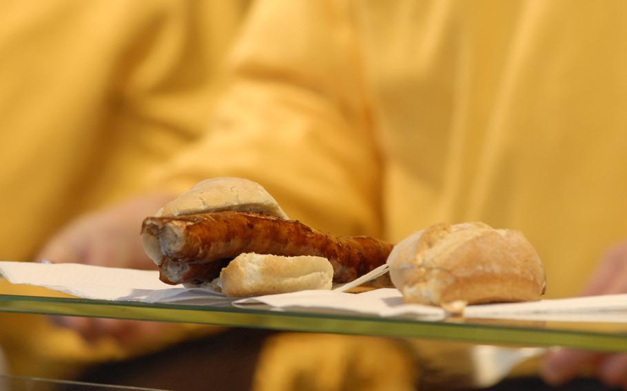 A long, skinny bratwurst is served in a roll during the annual Christmas market in Speyer, Germany, in December 2013.