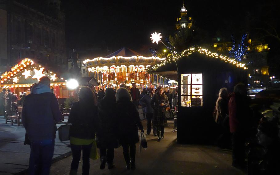 The European Christmas Market's amusement rides and vendors' stalls light up East Princes Street Gardens in Edinburgh, Scotland.