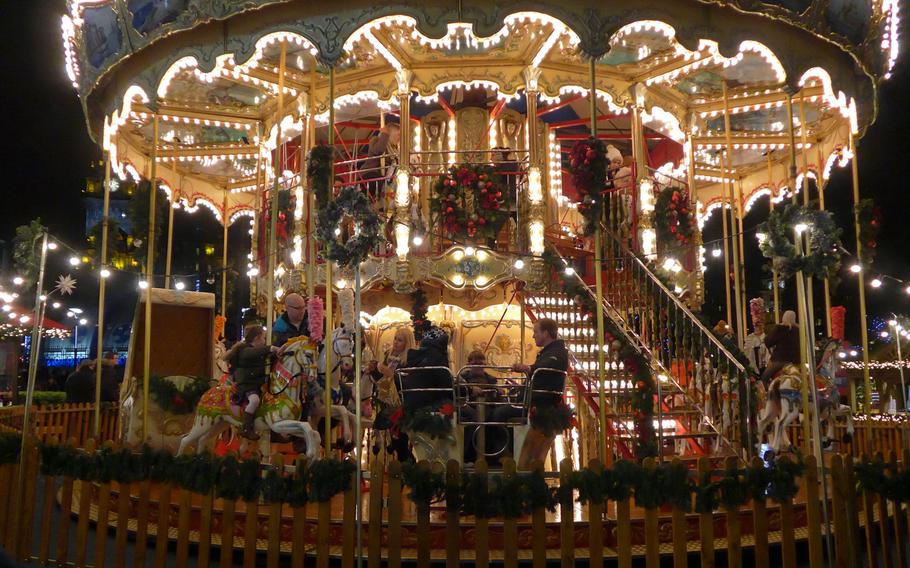 Children ride the double-tiered merry-go-round at the  European Christmas Market in Edinburgh, Scotland, in December 2013. There is a second carousel at the Scottish Market on St. Andrew Square.