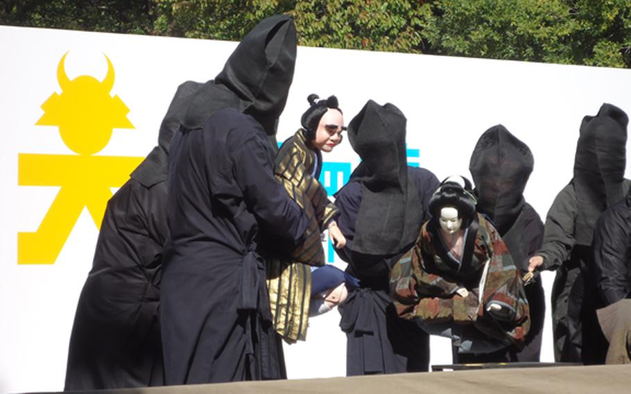 Actors perform a puppet show at Osaka Castle.
