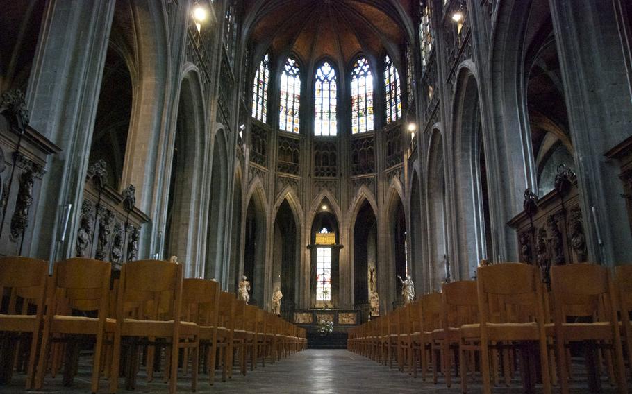 The massive interior of the Colegiate Church of St. Waudru in Mons offers stunning windows and beautiful sculptures.