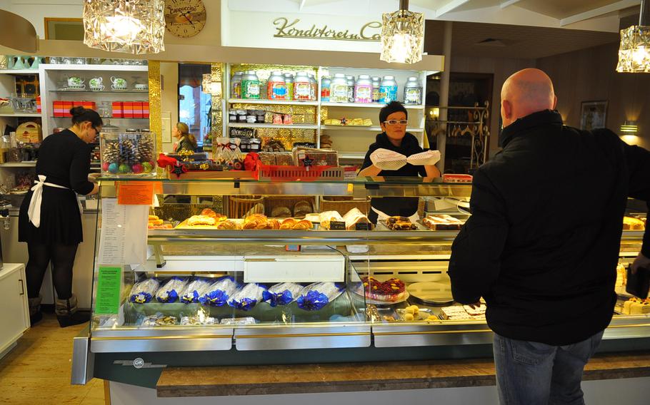 A customer picks up some baked goods at Café Krummel. One of the cafe's more popular cakes is called Byzantiner. The cake is make with an almond paste and chocolate mousse.