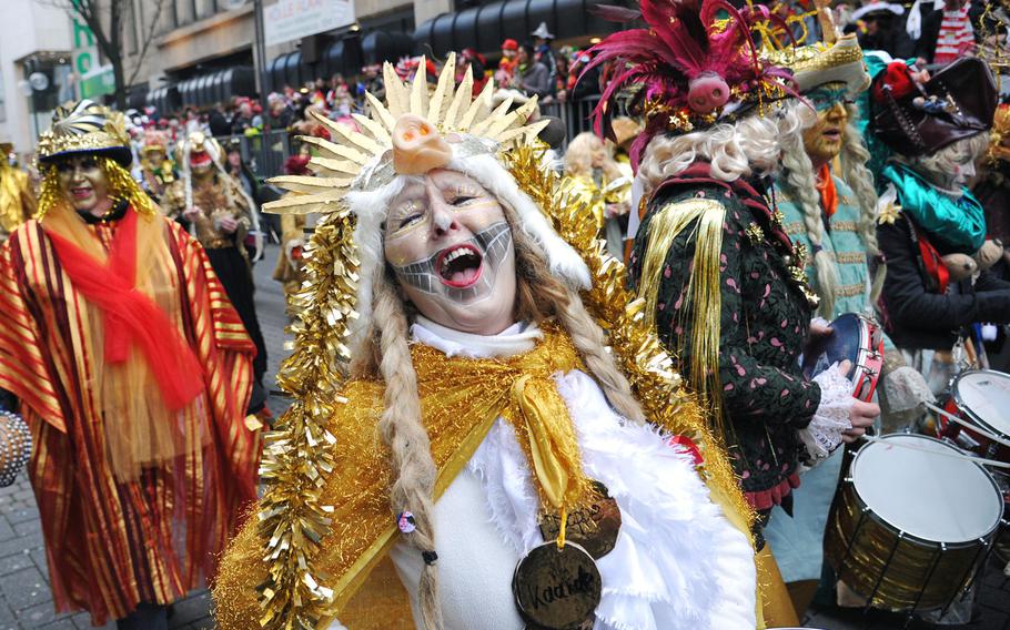 A participant at the 2014 Cologne Rose Monday parade shouts the greeting of the Cologne Carnival ''Kölle  Alaaf!'' Hundreds of thousands of people line the streets of Cologne for the highlight of the city's Carnival celebrations.