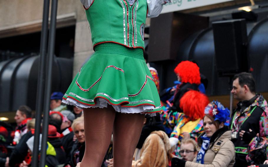 A dancer of a carnival dance groups rides on the shoulders of a club mate during the 2014 Cologne Rose Monday parade.  