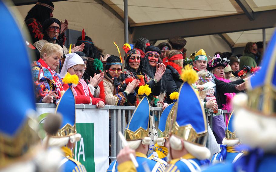 Spectators at the 2014 Cologne Rose Monday Carnival parade watch a band march by. More than 80 bands participated in last year's parade.