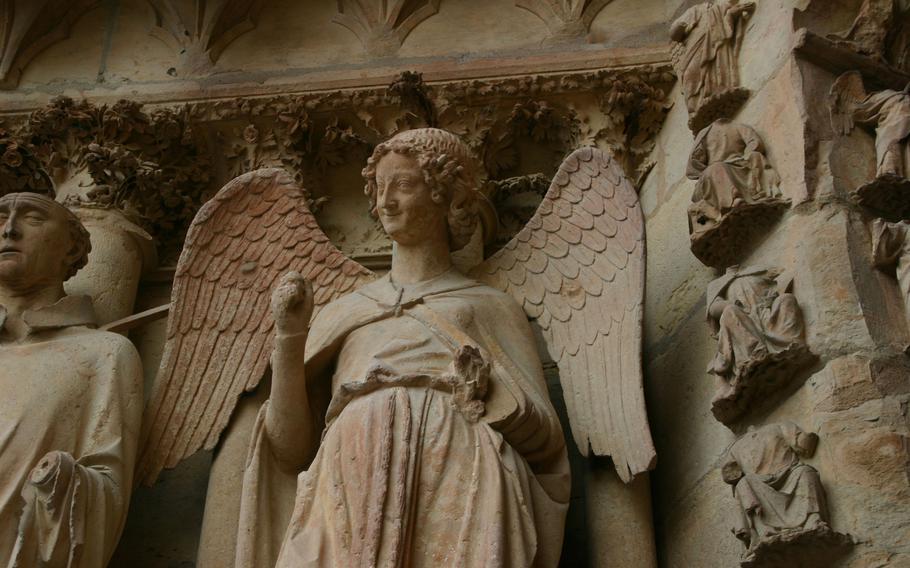At the entrance to the cathedral, a smiling angel greets visitors. The statue became the city's symbol after World War I, and the smiling face graces bridges across the city.