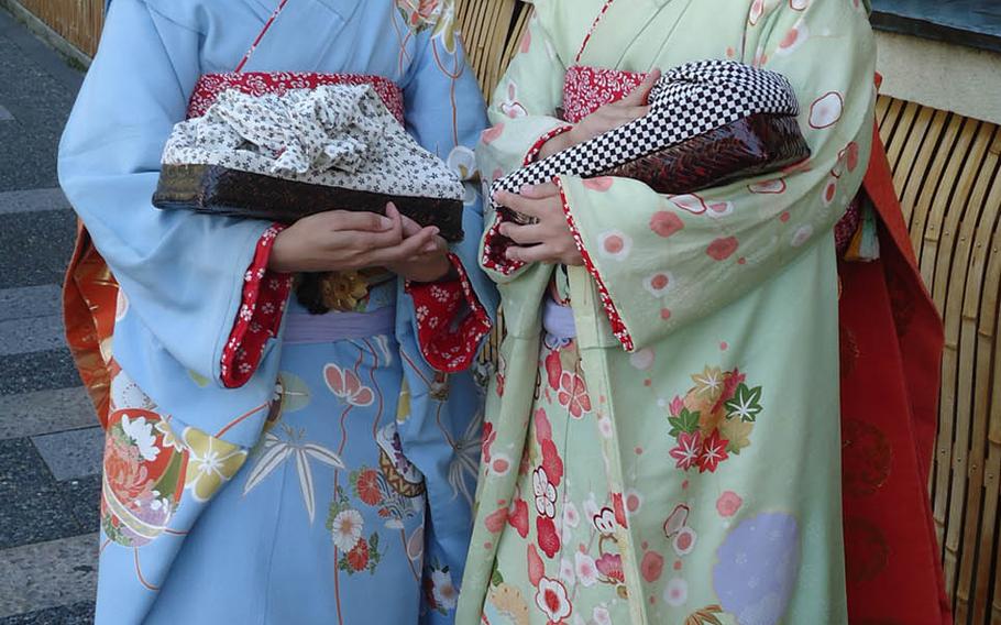 The geisha, another symbol of Japanese culture, has deep roots in Kyoto. These two paused for a photo on the street en route to Kinkaku-ji.